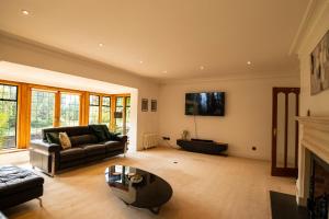 a living room with a couch and a fireplace at Chimneys Hot Tub Country Escape in Stourbridge