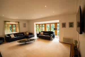 a living room with couches and a coffee table at Chimneys Hot Tub Country Escape in Stourbridge