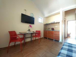 a room with a table and chairs and a kitchen at Apartments Premier in Budva +3 photos