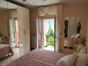 a bedroom with two beds and a large window at Affittacamere Cinque Terre Route 66 in Carrodano Inferiore
