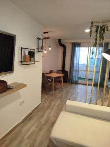 a living room with a couch and a table at La casita del albaicin in Málaga