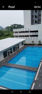 a large swimming pool in front of a building at Anderson Condo ipoh in Ipoh