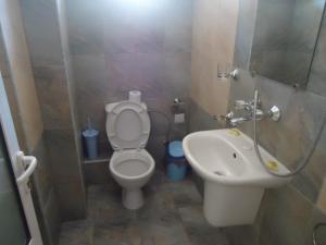 a bathroom with a toilet and a sink at Тихия кът in Sozopol