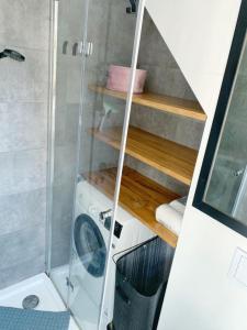 a washing machine in a bathroom with a shower at Marina Mikołajki in Mikołajki +34 photos