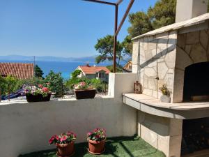 a balcony with potted plants and a view of the water at Kuća za odmor Skalina - Sea view in Splitska