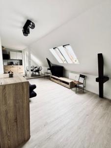 an attic living room with skylights and a table and chairs at Ferienidyll an der Recknitz in Tessin