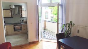 a kitchen with a door open to a patio at Ferienwohnung Cottbuser City II in Cottbus