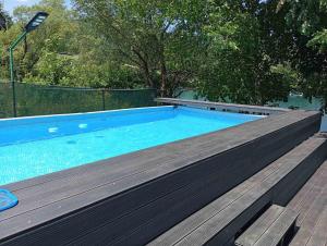 a large swimming pool with a wooden deck next to it at Holiday Home Racic in Bihać