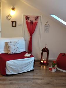 a bedroom with a bed and a red curtain at Le Grenier Apartment in Turin