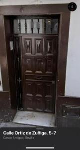 a large wooden door in a building at Apartamento las setas in Seville