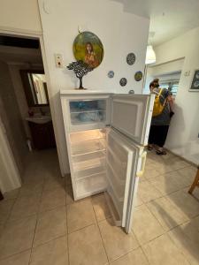 a refrigerator with its door open in a kitchen at Comfort on the ground in Haifa +6 photos