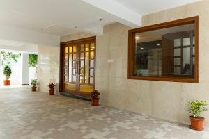 a lobby with a large mirror on the wall at The Viva Grand in Chennai