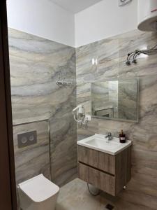 a bathroom with a sink and a toilet at Arber Premium Apartment in Durrës +29 photos