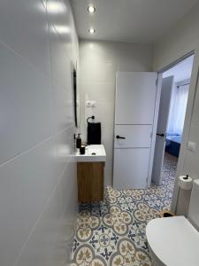 a kitchen with a white refrigerator and a tile floor at Casa Azul in Málaga +27 photos