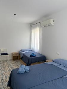 a room with two beds and a window at Casa Azul in Málaga