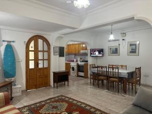 a kitchen and dining room with a table and chairs at Villa Truva in Fethiye