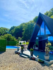 a blue tent with potted plants next to a pool at Vila Edi Tuzla in Tuzla