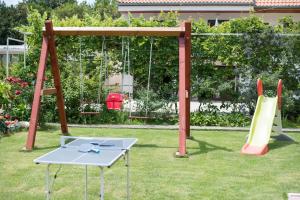 a playground with a table and a slide at Apartmani Tabain I in Mlini