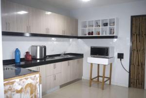 a kitchen with a counter and a microwave in it at casa hotel trebol 2 en 1 baño al lado in Cali