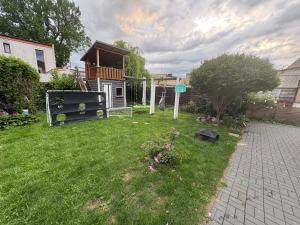 a backyard with a gazebo in the grass at White house in Malbork
