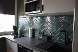 a kitchen with a sink and a microwave at Apartment Deich 70 in Bremerhaven +11 photos