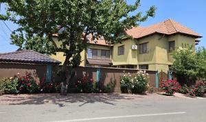 a large house with flowers in front of it at Villa Mugur in 2 Mai