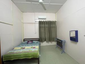a small room with a bed and a window at FAKIH Homestay in Tumpat
