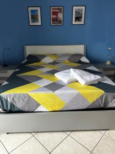 una cama con una colcha colorida en un dormitorio en Casa di Luisa, en Savigliano