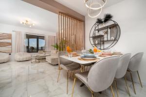 a dining room with a table and chairs at Luxury Dream House Nea with jacuzzi in Makarska