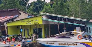 a boat is parked in front of a building at King seafood koh kood in Ban Khlong Mat