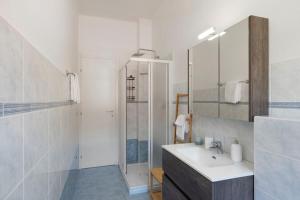 a white bathroom with a sink and a shower at Maison Petrolini - Maggiore Estate by Ginin in Cannobio +21 photos
