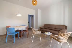a living room with a couch and a table and chairs at Maison Petrolini - Maggiore Estate by Ginin in Cannobio