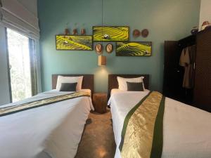 two beds sitting in a room with at Inco Villa in Ban Nong Chaeng