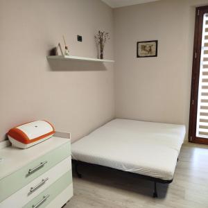 a small bedroom with a bed and a dresser at Casa Rossy in Pieve San Giacomo