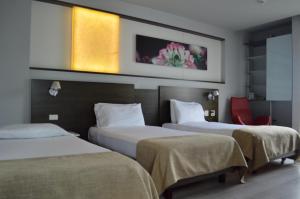 Postel nebo postele na pokoji v ubytování Inntu Hotel