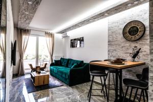 a living room with a green couch and a table at Apartman Despot LUX in Banja Koviljača