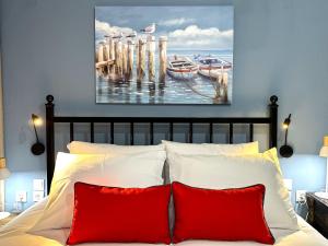 a bedroom with a bed with two red pillows at Colorsphere in Thessaloniki