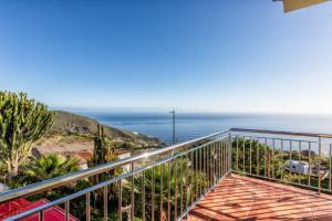 a balcony with a view of the ocean at Casa Conrado, 2 bedroom modern oasis, good location in Puntallana