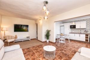 a living room with a couch and a table at Casa Conrado, 2 bedroom modern oasis, good location in Puntallana +13 photos