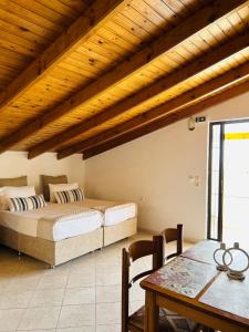a bedroom with a bed and a table in a room at Paradises's Nest in Agios Georgios