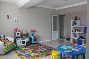 a childs play room with a table and a rug at Vemara City Boutique Hotel-free parking in Varna City