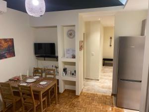 a kitchen and dining room with a table and a refrigerator at City Center Apartment in Ioannina