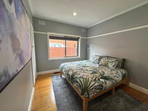 a bedroom with a bed and a window at Big home perfect for the whole group in Morwell