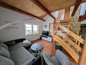 a living room with a couch and a staircase at Ferienhaus Marx in Sebnitz