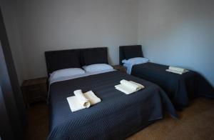a bedroom with two beds with towels on them at Ela's apartment 1 in Durrës