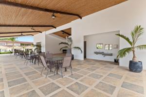 a dining room with a table and chairs and a table at Cozy 3BR Townhouse Near Tamarindo-2 Pool&More in Santa Cruz