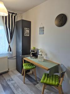 a dining room with a table and a microwave at Dream Studio Petrosani in Petroşani
