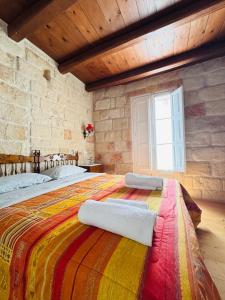 a bedroom with a large bed with a colorful blanket at Casa Vacanze Moonlight in Polignano a Mare