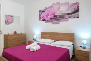 Un dormitorio con dos camas con una manta morada. en Edy sweet house, en Castro di Lecce