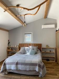 a bedroom with a bed with a wooden headboard at Maison de vacances in Le Thor +21 photos